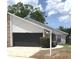 Traditional home exterior featuring a two-car garage, well-kept lawn, and attractive landscaping at 5284 Indian Laurel Ct, Orlando, FL 32808