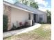 Charming home exterior with brick and stucco accents, complemented by lush landscaping and a well-manicured lawn at 5284 Indian Laurel Ct, Orlando, FL 32808