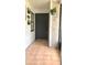 Inviting front entry with stylish black door and tiled porch at 5284 Indian Laurel Ct, Orlando, FL 32808