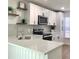 Modern kitchen with quartz countertops, stainless steel appliances, and stylish backsplash at 5284 Indian Laurel Ct, Orlando, FL 32808