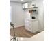 Kitchen with white cabinets, quartz counters, and floating shelves at 5284 Indian Laurel Ct, Orlando, FL 32808