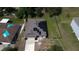 Aerial view of home with solar panels on roof, fenced yard, and driveway at 543 Nardello Dr, Deltona, FL 32725