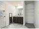 Well-lit bathroom featuring a vanity with storage, a large mirror, and tile flooring at 543 Nardello Dr, Deltona, FL 32725