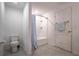 Clean bathroom featuring a shower with a blue striped curtain, toilet, and towel rack at 543 Nardello Dr, Deltona, FL 32725