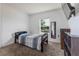 Bedroom featuring carpet, a window with blinds, and a bed with patterned comforter at 543 Nardello Dr, Deltona, FL 32725