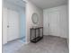 A welcoming entryway showcases a stylish table, mirror, and tile flooring at 543 Nardello Dr, Deltona, FL 32725