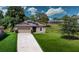 Charming one-story home features a well-maintained lawn, a two-car garage, and solar panels at 543 Nardello Dr, Deltona, FL 32725