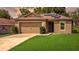 Inviting single-story home with a well-manicured lawn, two car garage, and cozy covered entrance at 543 Nardello Dr, Deltona, FL 32725