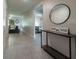 A bright hallway showcases a stylish table, mirror, and leads into the living area and bedroom at 543 Nardello Dr, Deltona, FL 32725