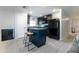 A well-lit kitchen offers black appliances, a center island with seating, and tile flooring at 543 Nardello Dr, Deltona, FL 32725