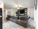 Spacious living room with a large gray modular sofa and entertainment center with fireplace at 543 Nardello Dr, Deltona, FL 32725