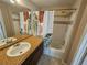 This bathroom features tiled floors, cabinet sink, mirror and shower at 5525 Pga Blvd # 4611, Orlando, FL 32839