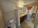 A bathroom with tiled floors, cabinet sink and shower at 5525 Pga Blvd # 4611, Orlando, FL 32839