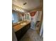 A bathroom with tiled floors, cabinet sink, mirror and shower at 5525 Pga Blvd # 4611, Orlando, FL 32839