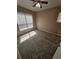 This carpeted bedroom features a ceiling fan and natural light through large windows at 5525 Pga Blvd # 4611, Orlando, FL 32839