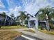 Exterior view of condo building with lush landscaping, walkways, and ample parking at 5525 Pga Blvd # 4611, Orlando, FL 32839