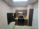 Efficient kitchen features black appliances, ample cabinet space, and durable countertops for easy meal preparation at 5525 Pga Blvd # 4611, Orlando, FL 32839