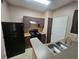 Efficient kitchen showcases black appliances, practical countertops, and a convenient double sink at 5525 Pga Blvd # 4611, Orlando, FL 32839