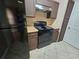 Kitchen with black appliances, practical countertops, and plenty of cabinet storage for organized cooking at 5525 Pga Blvd # 4611, Orlando, FL 32839