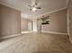 Relaxing living room features tile flooring, a ceiling fan, and neutral paint at 5525 Pga Blvd # 4611, Orlando, FL 32839
