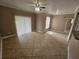 Comfortable living room with tile floors, natural lighting, and ceiling fan at 5525 Pga Blvd # 4611, Orlando, FL 32839