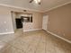Open-concept living area with tile flooring, open to the kitchen and entryway at 5525 Pga Blvd # 4611, Orlando, FL 32839