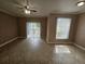 Bright living room with tile flooring, window and sliding glass door to balcony at 5525 Pga Blvd # 4611, Orlando, FL 32839