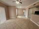 Spacious living room showcasing tile flooring, a ceiling fan, and natural light at 5525 Pga Blvd # 4611, Orlando, FL 32839
