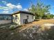 The back of a single story home with neutral siding and yard at 628 Cardinal St, Ocoee, FL 34761