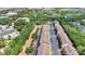 Aerial view of a neighborhood with rows of townhomes, lush green trees, and parking areas at 628 Pensacola Ln # 628, Lake Mary, FL 32746