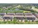 Aerial view of a residential neighborhood with townhomes, landscaping, golf course, and pond at 628 Pensacola Ln # 628, Lake Mary, FL 32746