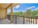 Spacious outdoor balcony overlooking green trees and blue skies with tiled floors at 628 Pensacola Ln # 628, Lake Mary, FL 32746