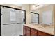Bathroom features a glass-enclosed shower, a vanity with granite counters and cabinets at 628 Pensacola Ln # 628, Lake Mary, FL 32746