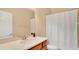 Well-lit bathroom with a single sink vanity and shower with a shower curtain at 628 Pensacola Ln # 628, Lake Mary, FL 32746
