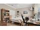 Neutral bedroom with light wood floor, small television, and large window at 628 Pensacola Ln # 628, Lake Mary, FL 32746