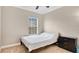 Bright bedroom featuring a cozy bed, neutral walls, and a dark wood dresser for ample storage at 628 Pensacola Ln # 628, Lake Mary, FL 32746