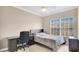 Bedroom featuring a bed, a desk, and a view from the window with bright light at 628 Pensacola Ln # 628, Lake Mary, FL 32746