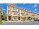 Three-story townhomes with neat landscaping, shutters, and convenient parking spaces in front at 628 Pensacola Ln # 628, Lake Mary, FL 32746