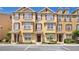 Beautiful three story townhomes featuring decorative shutters, landscaping, and convenient parking spaces at 628 Pensacola Ln # 628, Lake Mary, FL 32746