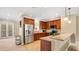 Updated kitchen featuring stainless steel appliances, wooden cabinetry, and an open concept design at 628 Pensacola Ln # 628, Lake Mary, FL 32746