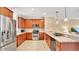 Well-equipped kitchen features modern stainless steel appliances, wood cabinets, and open layout to the living space at 628 Pensacola Ln # 628, Lake Mary, FL 32746