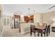 Open kitchen with stainless steel appliances, breakfast bar, and adjacent dining area at 628 Pensacola Ln # 628, Lake Mary, FL 32746