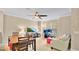 Bright living room features a ceiling fan, a comfortable couch, and a desk near the window at 628 Pensacola Ln # 628, Lake Mary, FL 32746