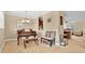 Inviting space features a piano, chandelier, bench seating, with views into another room at 628 Pensacola Ln # 628, Lake Mary, FL 32746