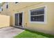 View of back patio with sliding door access, window and small grass area at 725 Cresting Oak Cir # 117, Orlando, FL 32824