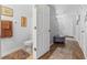 Bathroom with toilet, wood look flooring, and entry to main hallway at 725 Cresting Oak Cir # 117, Orlando, FL 32824