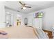 Bedroom featuring wood look flooring, bed, and an attached bathroom at 725 Cresting Oak Cir # 117, Orlando, FL 32824