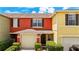Inviting two-story townhome featuring an attached one-car garage and well-manicured landscaping at 725 Cresting Oak Cir # 117, Orlando, FL 32824