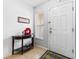 Inviting foyer with neutral walls, tile flooring, decorative table and front door at 725 Cresting Oak Cir # 117, Orlando, FL 32824