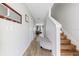 Bright hallway featuring wood-look flooring, neutral paint, and stairs at 725 Cresting Oak Cir # 117, Orlando, FL 32824